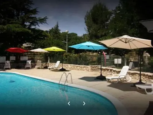 Shaded poolside terrace with parasols